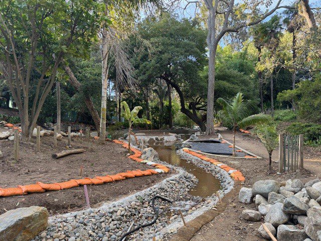 A landscaped garden path under construction with stone borders and gravel.
