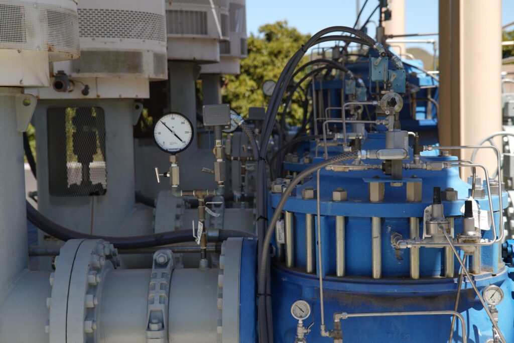 Industrial machinery with gauges and pipes outdoors.