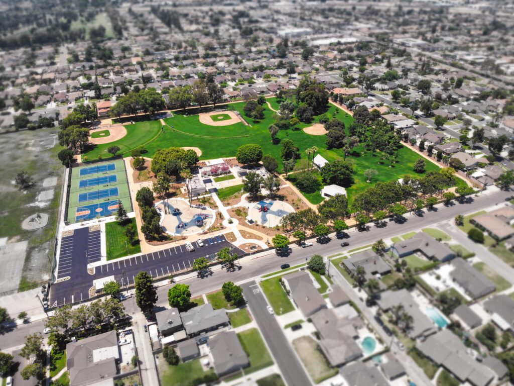 Aerial view of a city park with playgrounds and sports courts.