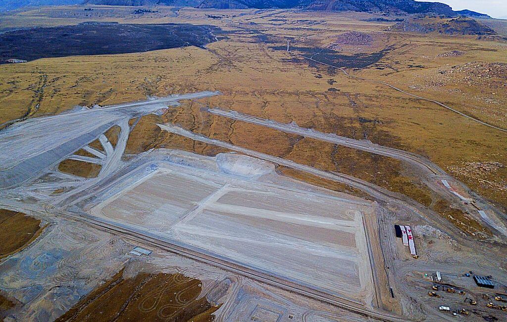 Aerial view of a large, rectangular excavation site in a barren landscape.