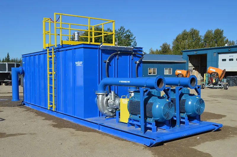 Industrial blue water treatment system with pumps and pipes.