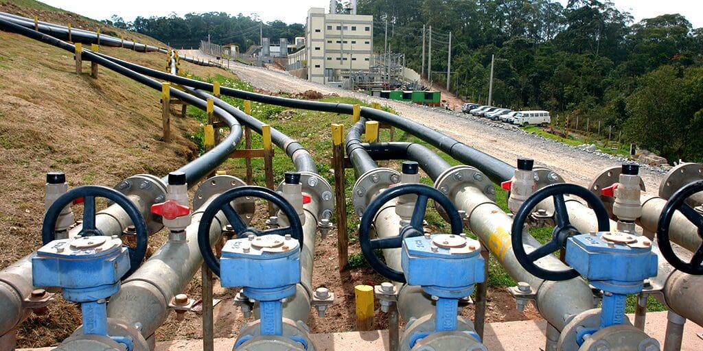 Industrial pipeline system with valves and control units outdoors.