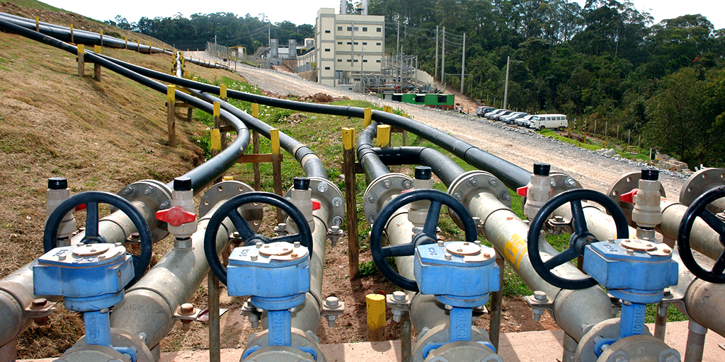 Industrial pipeline system with valves and control units outdoors.