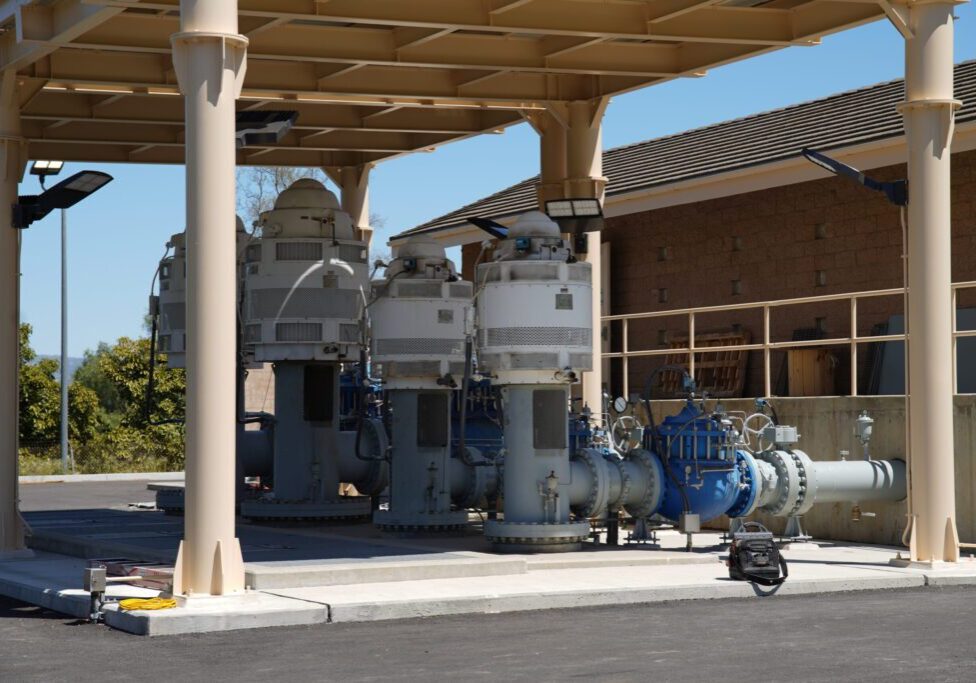 Industrial pumps and equipment under a shelter outdoors.