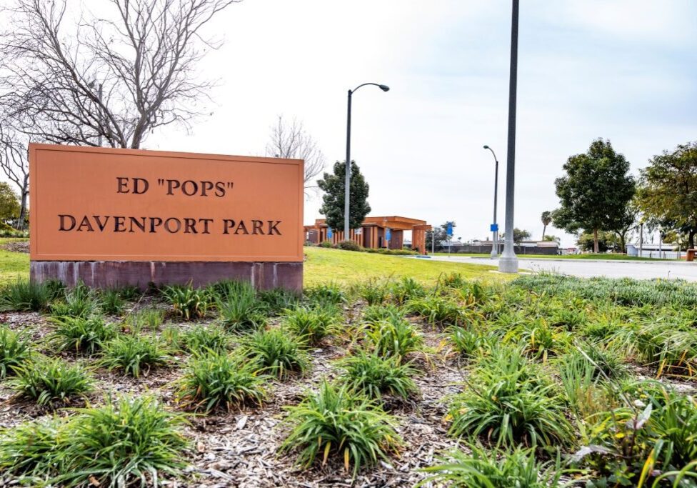 Entrance sign for Ed 'Pops' Davenport Park surrounded by greenery.